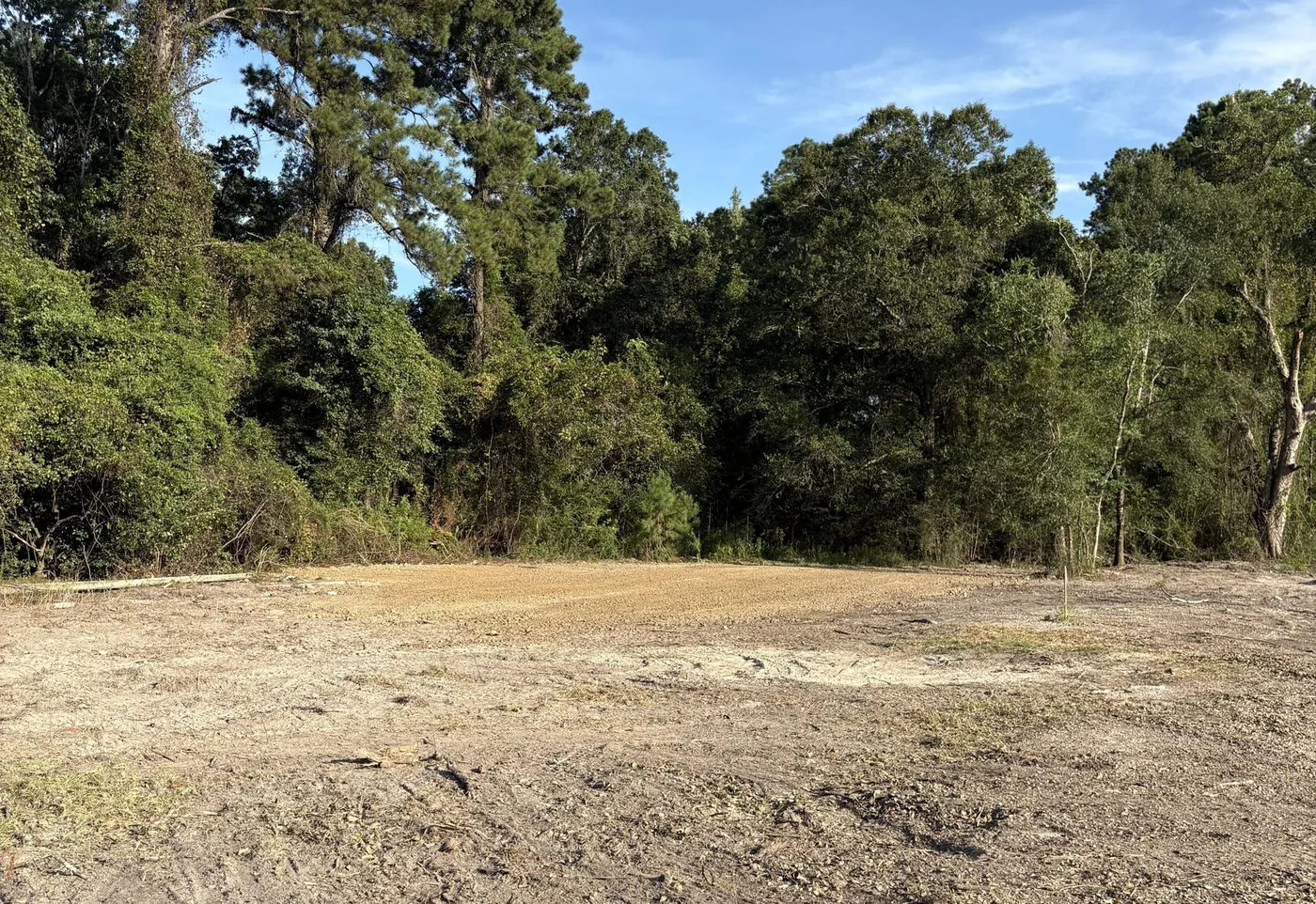 Cleared and graded lot with trees behind it near Hammond, LA