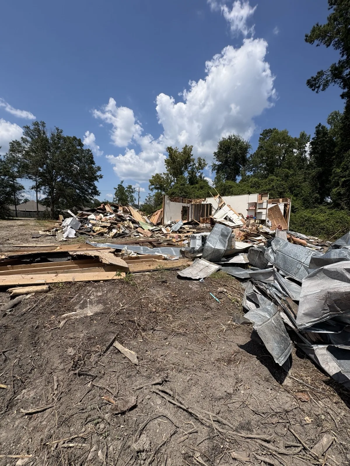 Demolition debris and torn-down structure on a residential lot near Hammond, LA