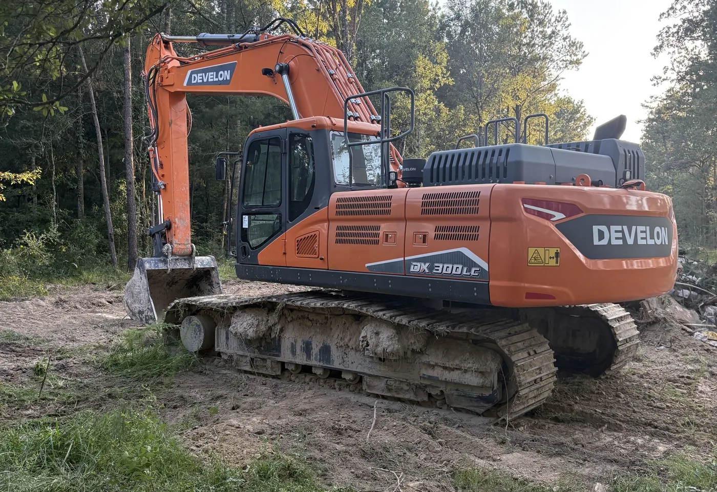 Large excavator parked on a cleared job site near Hammond, LA