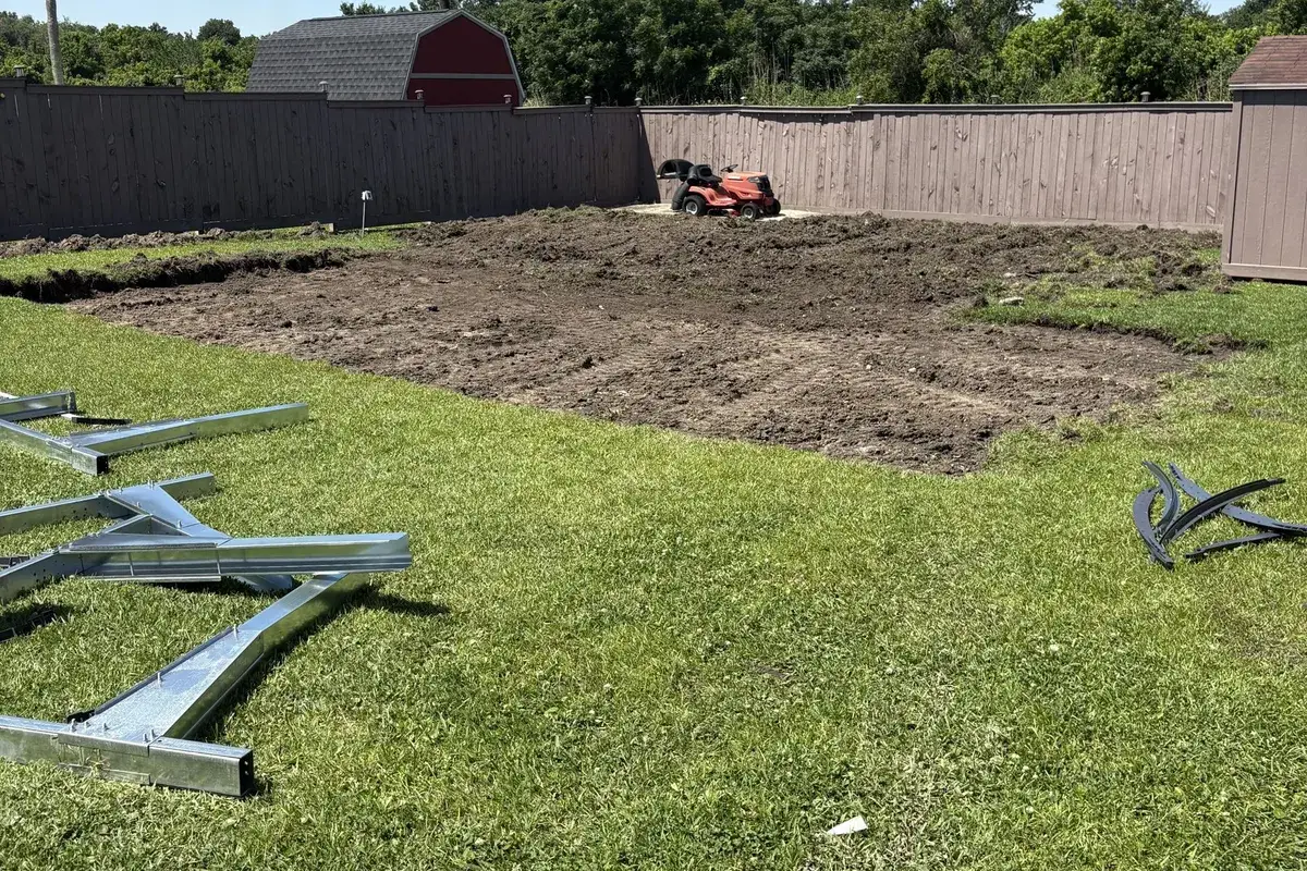 Fenced backyard with a freshly graded patch of dirt near Hammond, LA